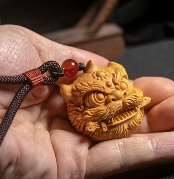Lion Biting Sword | Original Auspicious Beast Little Awakening Lion Pixiu Handheld Piece, Small Leaf Boxwood Carving, Handmade National Trend Collectible